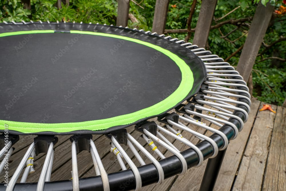 mini trampoline for fitness exercising and rebounding in a backyard patio, spring scenery